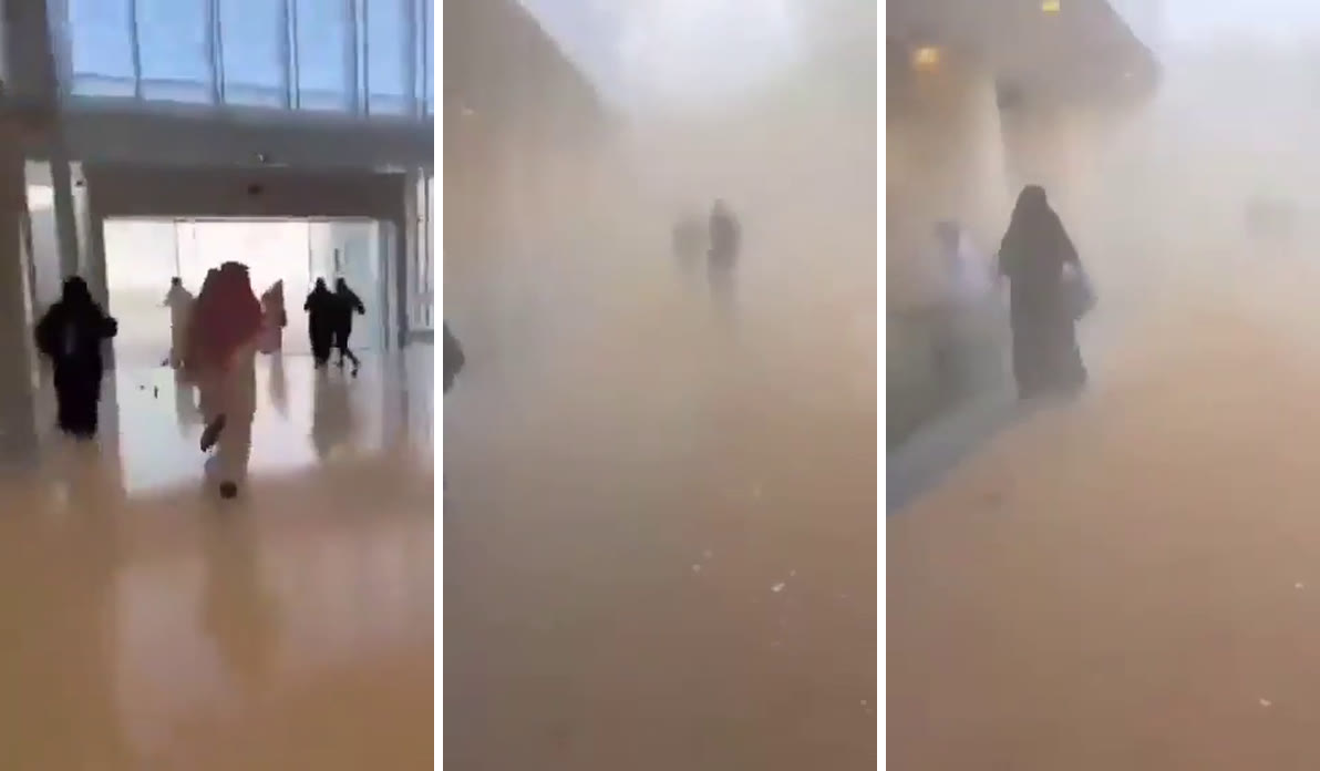Three frames from a phone video inside an airport terminal. In the first, people run toward glass doors in daylight. In the second, the hall has filled with tan dust and two figures are barely visible. In the third, a woman in a black abaya walks through the haze.